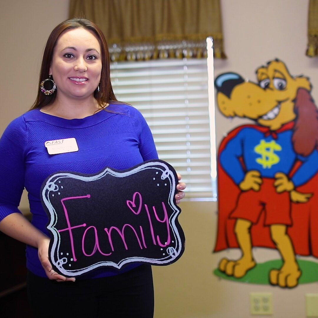 Employee holding a sign that says Family